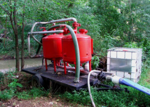 Fig. 11. A media filtration system is used to remove debris from the water source. Pesticide injection must be on the outlet side of all media filters to prevent contamination of filter media. 